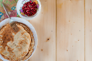 delicious rustic fragrant pancakes with lingonberries. Top view. Flat lay