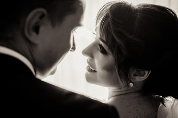 Fototapeta premium Look from behind at bride and groom admiring each other
