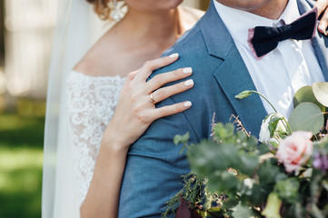 bride and groom together holding wedding bouquet
