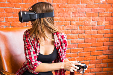 Fototapeta na wymiar Woman play video game with joystick and VR device