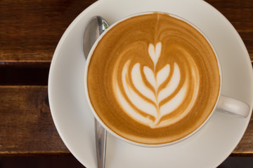 Latte cup on wooden table 