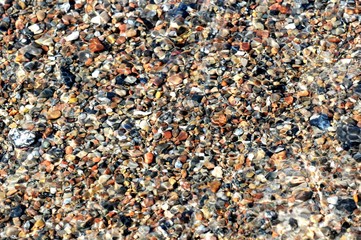 pebbles on beach of darsser ort in the waves.