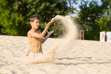 a boy plays on the beach