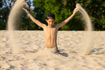 a boy plays on the beach