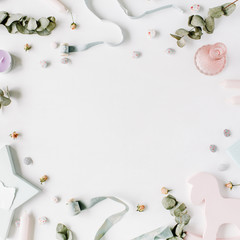 floral frame with rose buds, dry eucalyptus branches, candles, ribbon and buttons on white background. flat lay, top view