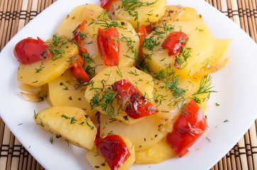 Close up view on a vegetarian dish with slices of stewed potatoe