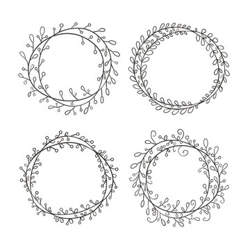 Set of round frames, hand-drawn. Round frame made of branches with leaves and berries.  Wreath painted by hand.