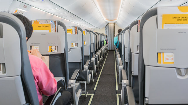 Fototapeta Passengers seated in the plane's cabin before plane taking off