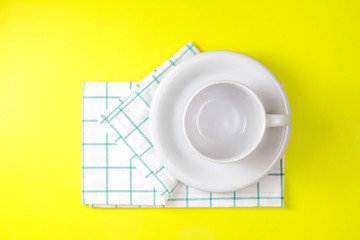 top view of empty white coffee or tea cup with towel on vibrant