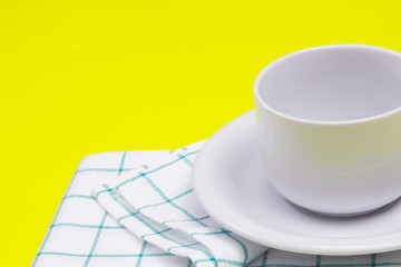  empty white coffee or tea cup with towel on vibrant color 