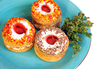 Three delicious cookies lying on blue plate.