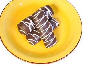 Chocolate chip cookies, lying on a yellow plate. Closeup.
