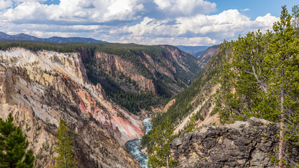 Fototapeta na wymiar Mountain landscape. Stormy river flows in a narrow gorge. Point sublime on the Grand Canyon of the Yellowstone, Yellowstone National Park, Wyoming