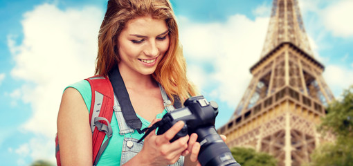 woman with backpack and camera over eiffel tower