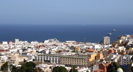 Oceans's city. Background: blue sea and ships.