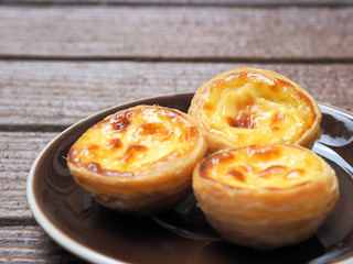 Delicious Asian Egg tart from the Hong Kong famous shop on the brown plate for healthy coffee break...