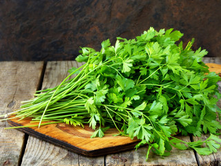 bunch of parsley on wooden background. selective focus