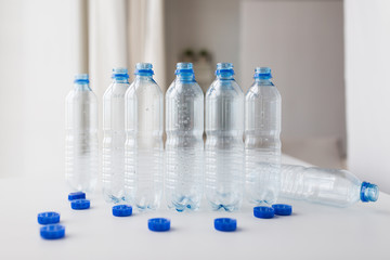 close up of empty water bottles and caps on table