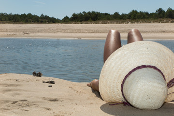 Fototapeta na wymiar Summer vacation woman on the beach in beach hat enjoying