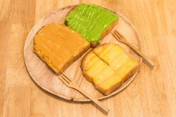 Bread toast with butter, custard, condensed milk