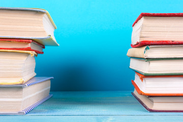 Stack of colorful books, grungy blue background, free copy space