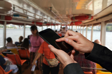 Obraz premium Woman hand hold and touch screen smart phone, cellphone on blurred abstract passenger ships background as communication and transportation concept.