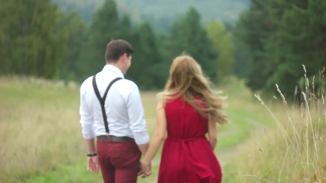 couple walking in the forest hand