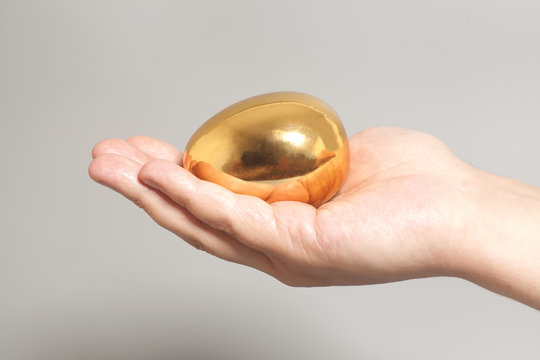 Golden egg in hand