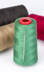 Sewing Threads and needle on white background