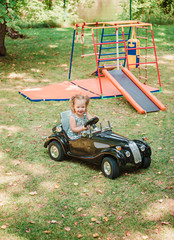 The little baby girl playing at car