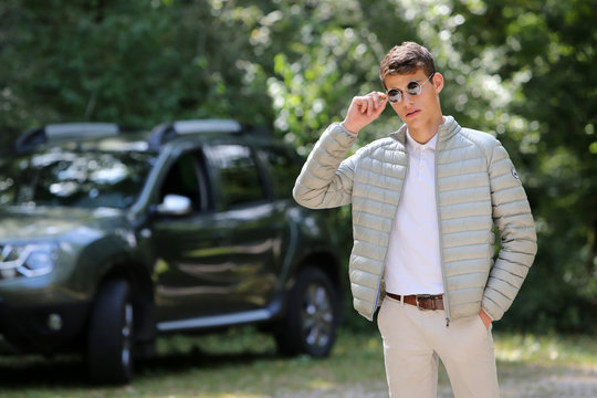 Young man with sunglasses and 4x4