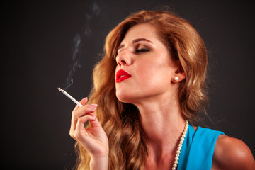 Fototapeta premium Portrait of girl who smokes cigarette. Smokes is bad habit.