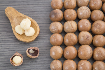 Nuts, macadamia nut on wooden background. From the top view