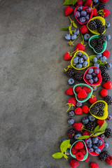 Tasty forest fruits on stone background.
