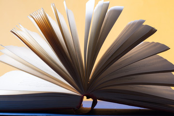 Open book, hardback books on wooden table. Education background. Back to school. Copy space for text