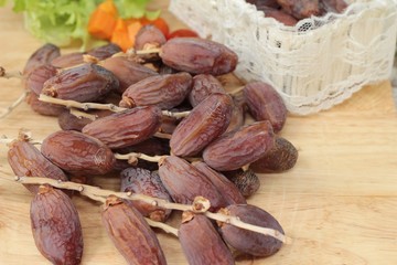 Dried date palm delicious on wood background.