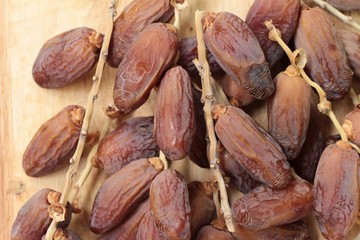 Dried date palm delicious on wood background.