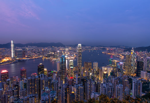 Hong Kong city skyline panorama at night with Victoria Harbor an
