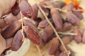 Dried date palm delicious on wood background.