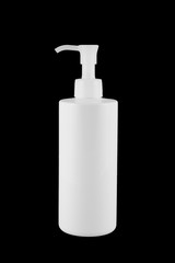 White plastic bottle with pump lid. It is isolated on black background.