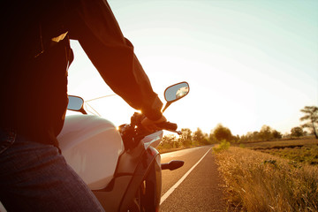 Moped drivers on road at sunset - Travel by motorcycle Concept