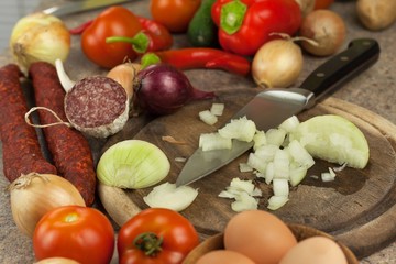 Slicing onions and tomatoes. Preparing diet meals. Chef slicing vegetables for a salad.
