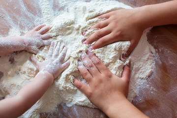 Child's hands playing with the flour