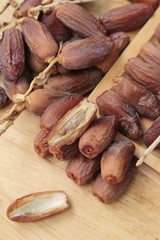 Dried date palm delicious on wood background.