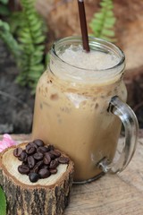 Iced coffee is delicious on wood background.