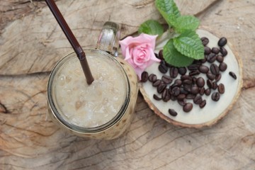 Iced coffee is delicious on wood background.