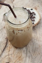 Iced coffee is delicious on wood background.