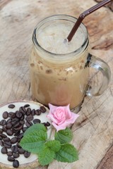 Iced coffee is delicious on wood background.
