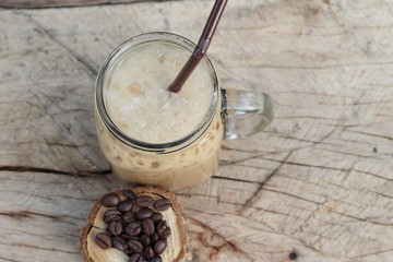 Iced coffee is delicious on wood background.