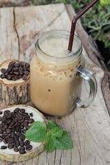 Iced coffee is delicious on wood background.